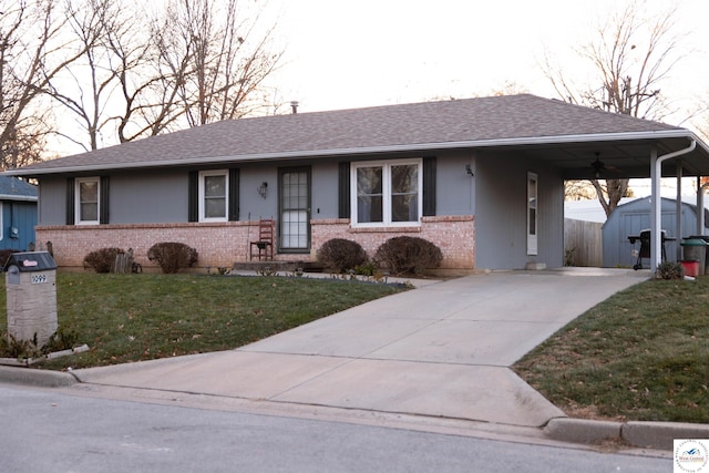 ranch-style house with an outbuilding, concrete driveway, a storage shed, and brick siding