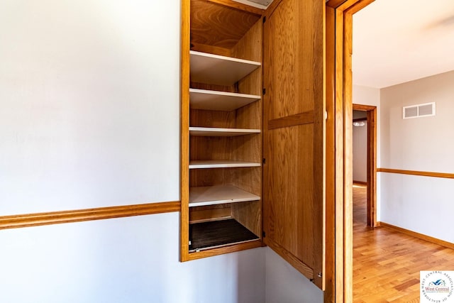 interior space with light wood-type flooring and visible vents