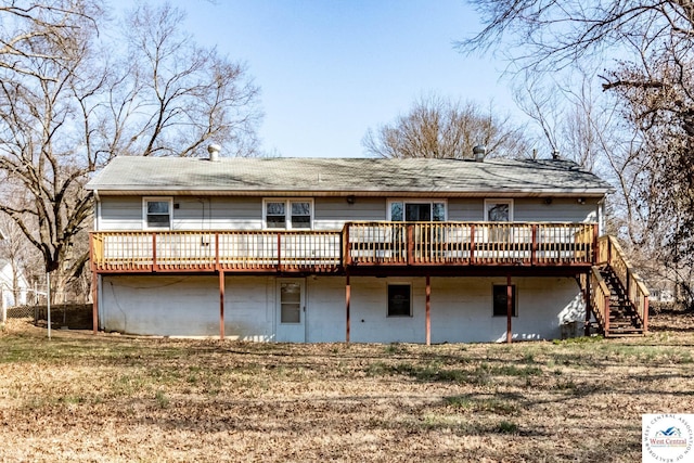 back of house featuring a yard, stairs, and a deck