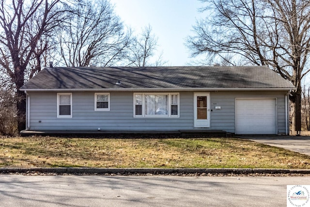 single story home featuring driveway, a front yard, and a garage