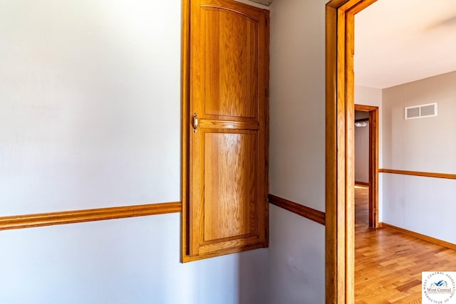 room details featuring visible vents, baseboards, and wood finished floors