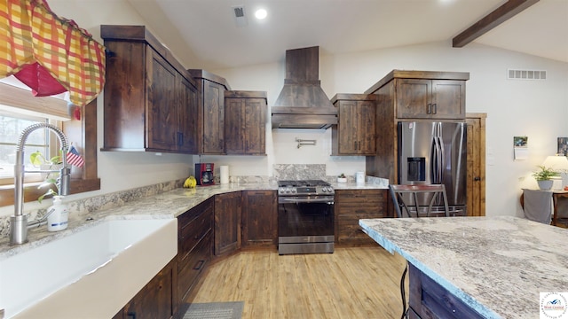 kitchen featuring appliances with stainless steel finishes, custom exhaust hood, visible vents, and light stone countertops