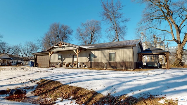 view of front of property featuring a garage and a gazebo