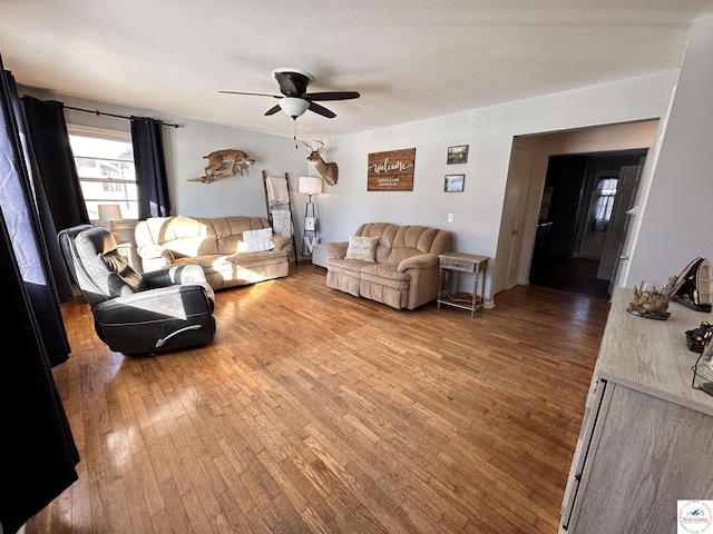 living area featuring ceiling fan and wood finished floors