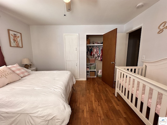 bedroom with dark wood-type flooring, a closet, and ceiling fan