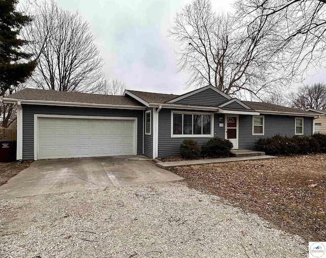 ranch-style house with an attached garage and concrete driveway