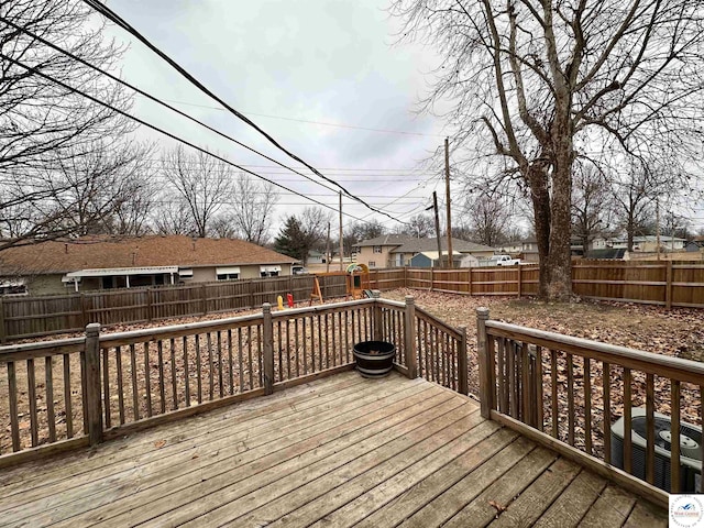 wooden terrace with a fenced backyard, a residential view, and central AC unit