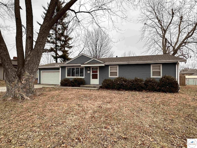 ranch-style house with a front yard, driveway, and an attached garage