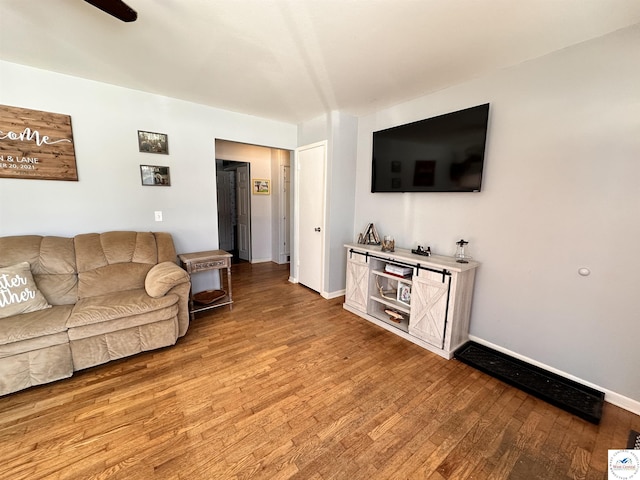 living room with light wood-style floors and baseboards