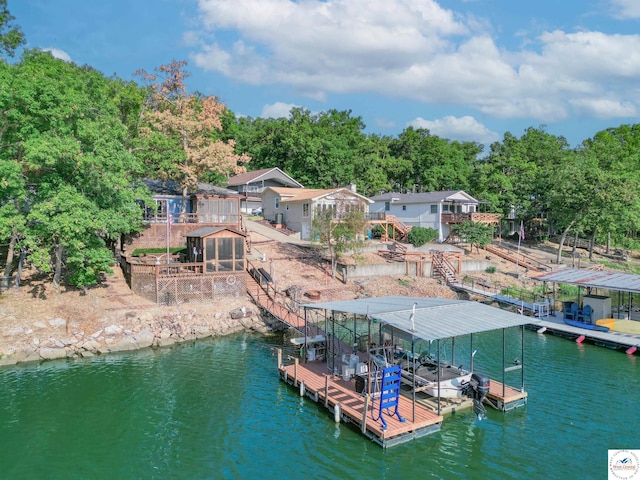 view of dock with stairway, a water view, and boat lift