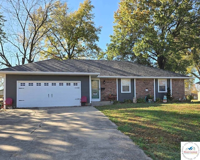 single story home with concrete driveway, a front lawn, an attached garage, and brick siding