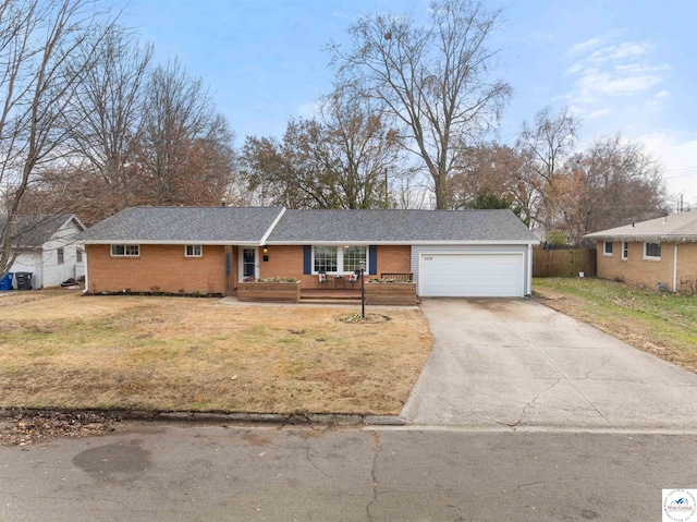 ranch-style house featuring a garage, brick siding, driveway, and a front lawn