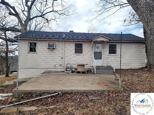 back of house featuring entry steps and a patio