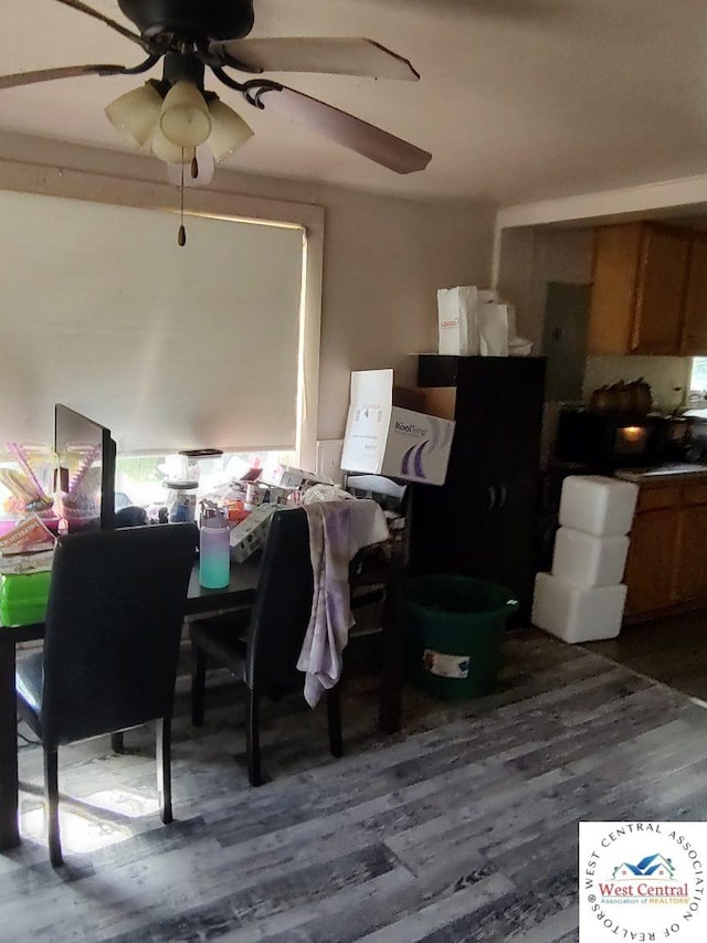 dining room with dark wood-type flooring and a ceiling fan