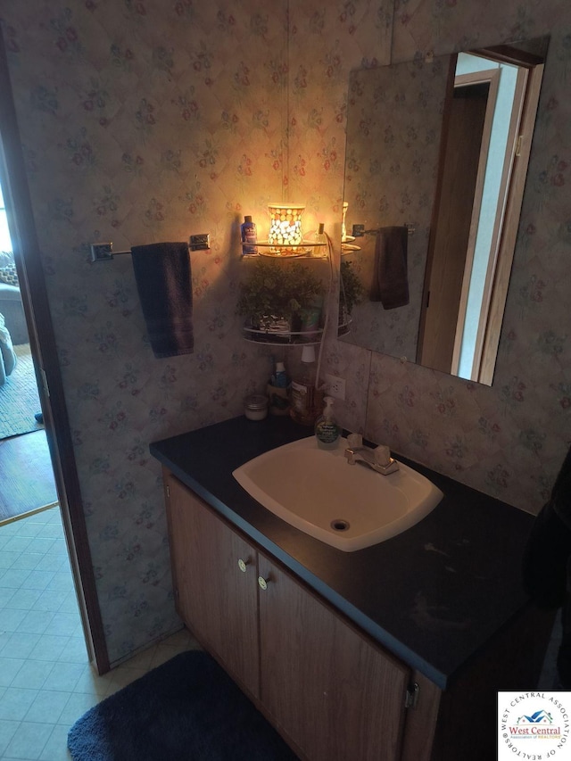 bathroom featuring tile patterned floors, vanity, and wallpapered walls