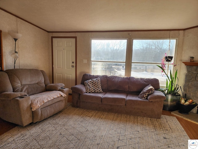 living room featuring plenty of natural light, light wood-style flooring, and ornamental molding