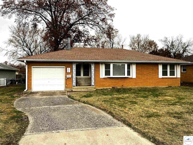 single story home with an attached garage, brick siding, driveway, and a front lawn