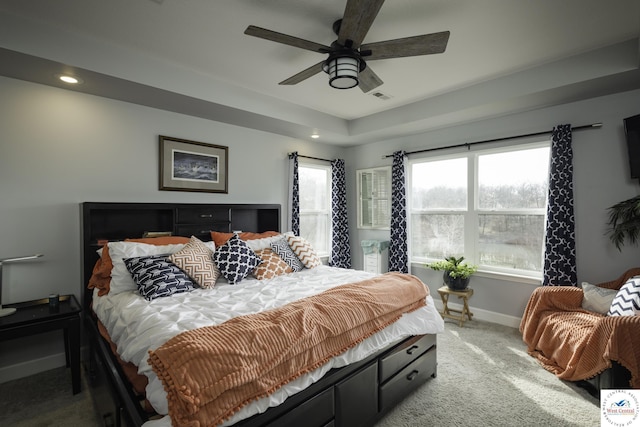 bedroom featuring visible vents, light carpet, multiple windows, and baseboards