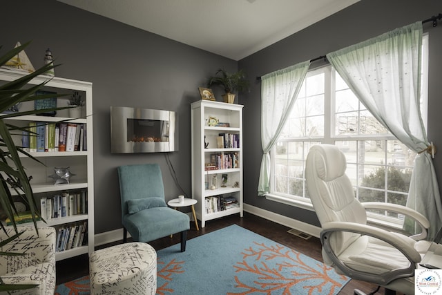 office with lofted ceiling, plenty of natural light, wood finished floors, and visible vents