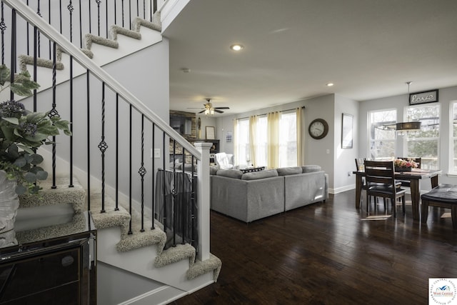 living room featuring wood finished floors, baseboards, a ceiling fan, recessed lighting, and stairs