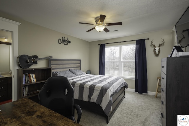 bedroom with visible vents, baseboards, ceiling fan, light colored carpet, and a textured ceiling