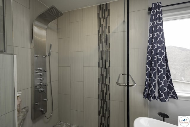 bathroom with tiled shower