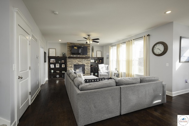 living room with recessed lighting, baseboards, dark wood-style flooring, and a fireplace