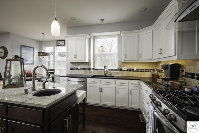 kitchen featuring white cabinets, tasteful backsplash, and a sink