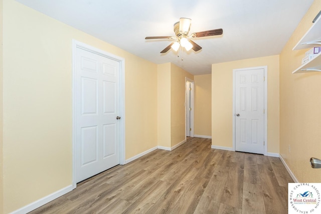 unfurnished bedroom featuring baseboards, wood finished floors, and a ceiling fan