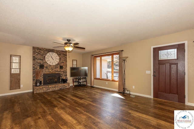 unfurnished living room with a fireplace, wood finished floors, baseboards, and a textured ceiling