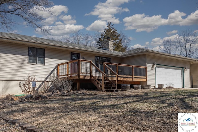 view of front of house featuring a wooden deck, an attached garage, a chimney, and stairs