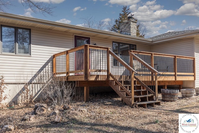 doorway to property featuring a deck and a chimney