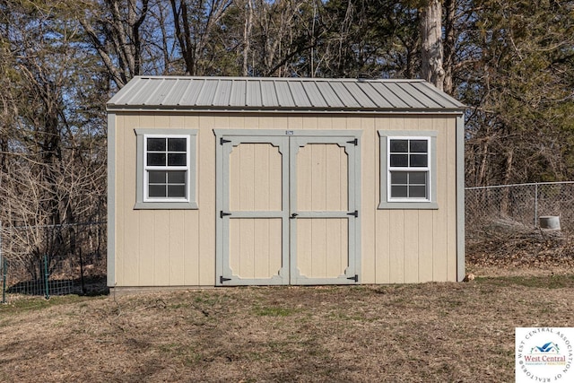 view of shed featuring fence