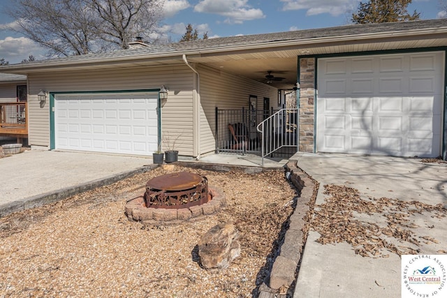 exterior space featuring ceiling fan and driveway