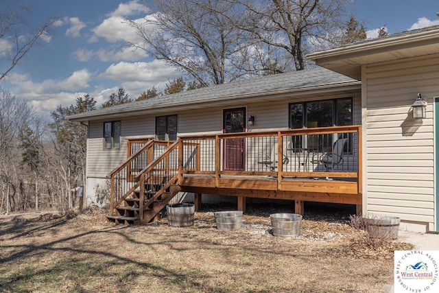 rear view of house featuring a wooden deck