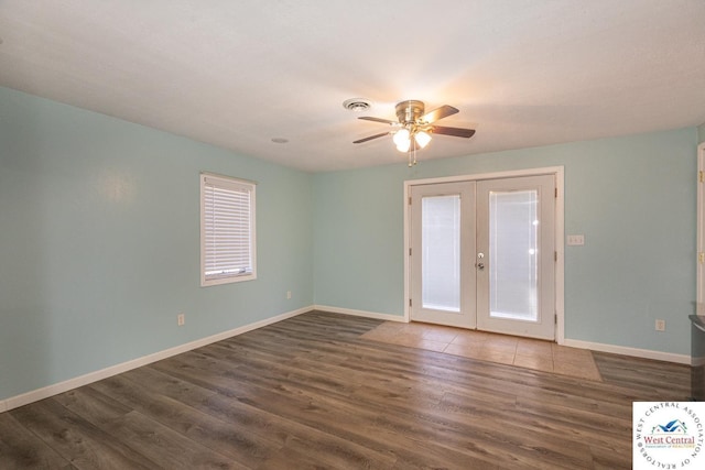 spare room with visible vents, baseboards, dark wood finished floors, ceiling fan, and french doors