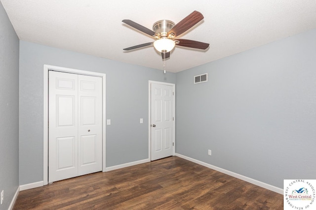 unfurnished bedroom with visible vents, baseboards, and wood finished floors