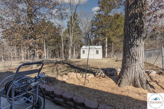 view of yard with a shed, an outdoor structure, and fence