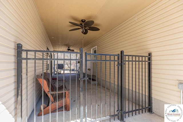 view of patio with a ceiling fan and a gate