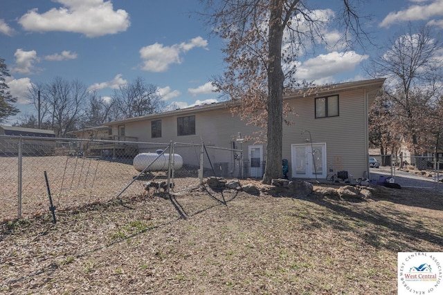 back of house featuring fence