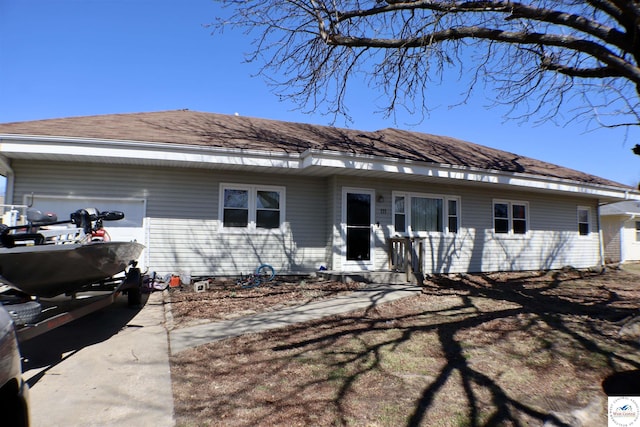 view of front of home with a garage and a shingled roof