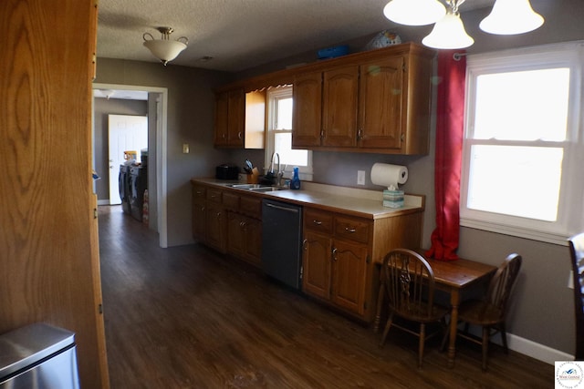 kitchen featuring dishwasher, light countertops, dark wood-style flooring, and a sink