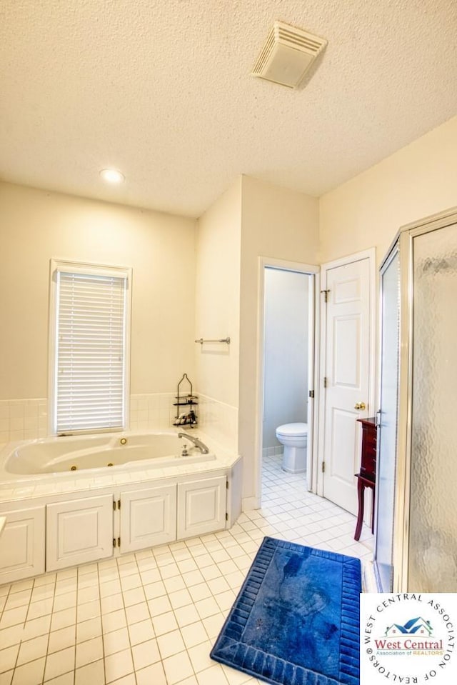 bathroom with a garden tub, toilet, tile patterned flooring, visible vents, and a stall shower