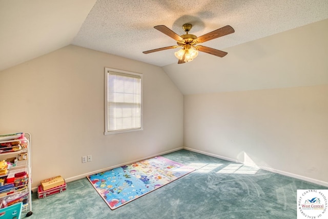 additional living space with carpet floors, vaulted ceiling, a textured ceiling, and ceiling fan