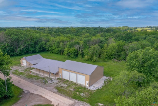 drone / aerial view featuring a forest view