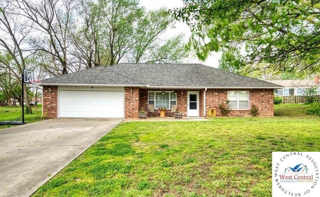 ranch-style home with an attached garage, concrete driveway, brick siding, and a front yard
