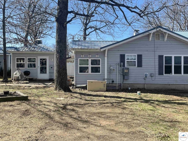 back of property featuring metal roof