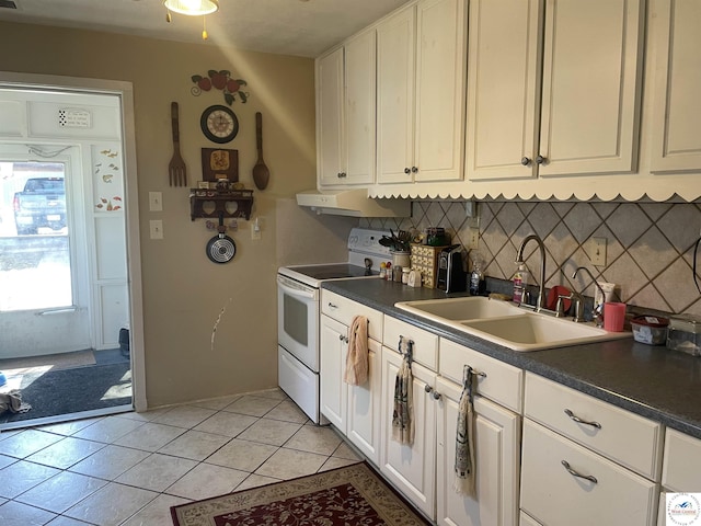 kitchen with light tile patterned floors, a sink, decorative backsplash, electric stove, and under cabinet range hood