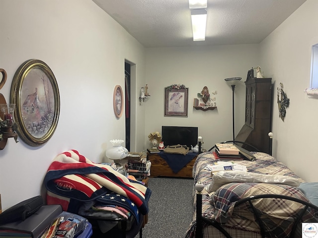 bedroom featuring carpet flooring and a textured ceiling