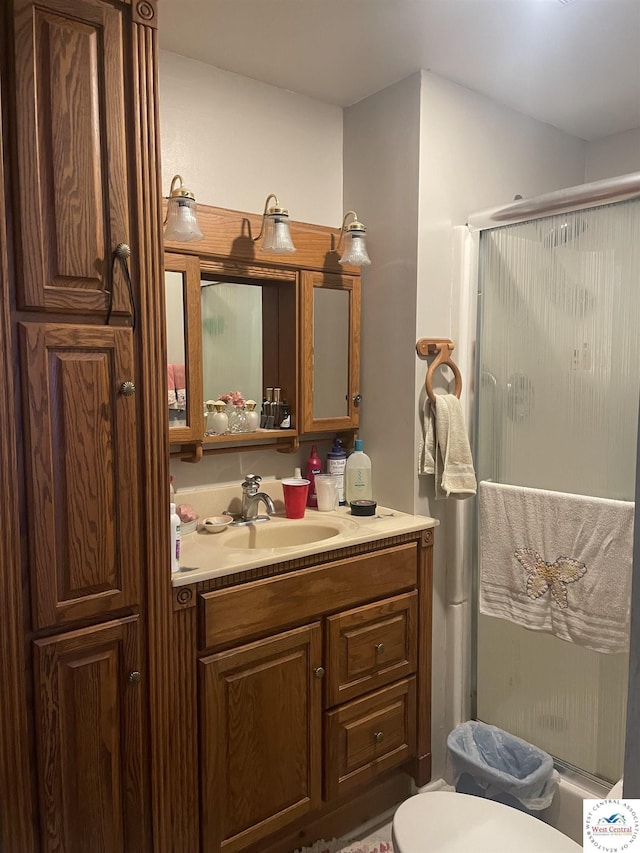 full bathroom featuring vanity, toilet, and a stall shower